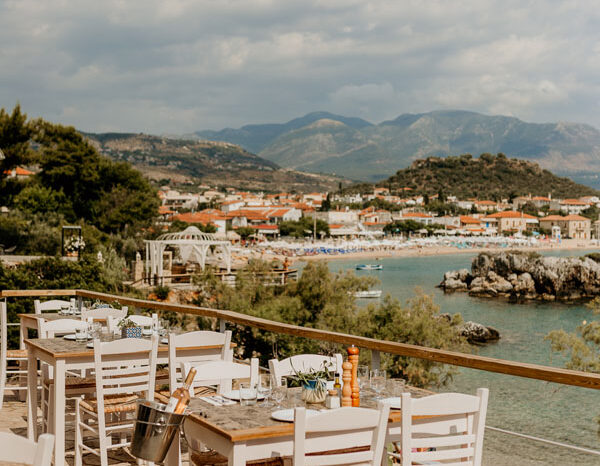 Morning terrace tables at Enigma cafe overlooking Stoupa bay and the Messenian Gulf