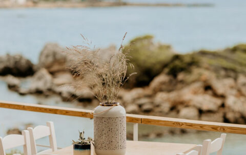 Tables set by the sea at Liastres restaurant in Stoupa