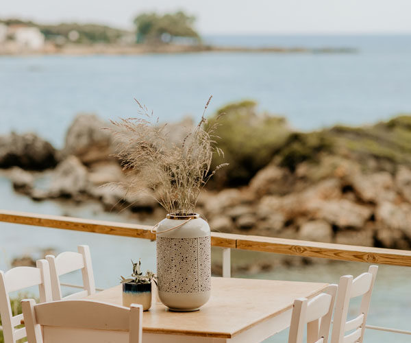 Tables set by the sea at Liastres restaurant in Stoupa