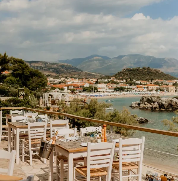 Morning terrace tables at Enigma cafe overlooking Stoupa bay and the Messenian Gulf